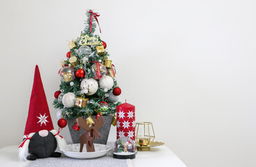 Festive decoration, a Christmas tree along with a santa soft toy, chocolate reindeer, Christmas...