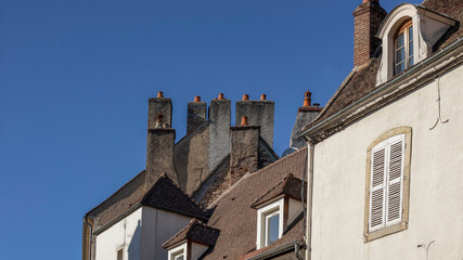 Multiple chimneys the roof tops of a french town