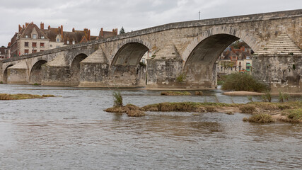Fototapeta premium Old stone bridge crossing the river Loire into a town