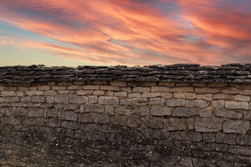 Stone wall and pink sky background