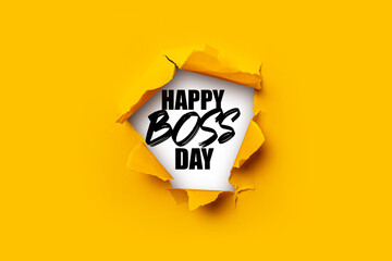 Bright yellow torn paper inside in a hole the inscription Happy boss day on a white background.