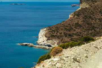 Cliff near the sea, seaside on the Greek island of Milos, a volcanic island with a white landscape