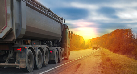 a truck is driving along the highway at sunset, a cargo transportation concept