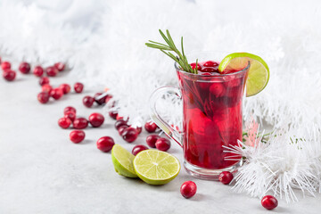 Christmas cranberry drink with berries, lime, and rosemary.