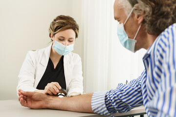 Dermatologist is using dermatoscope for skin examination in clinic