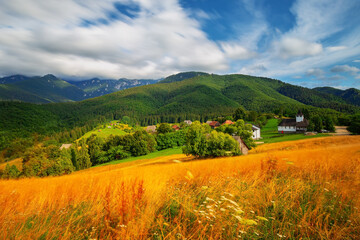 Fototapeta premium Long exposure photo of scenic landscape and mountain range in the backround near Brasov, Romania