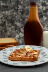 toasted bread in the foreground with banana and cajeta
