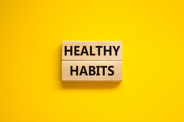 Time to healthy habits symbol. Concept words Healthy habits on wooden blocks on a beautiful yellow...