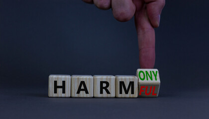 From harmful to harmony. Businessman turns the wooden cube and changes word harmful to harmony....
