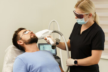 Man during beard photoepilation procedure