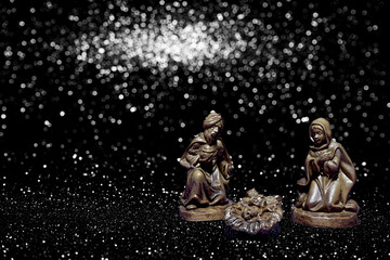 Christmas crib on stars background with space for text.
