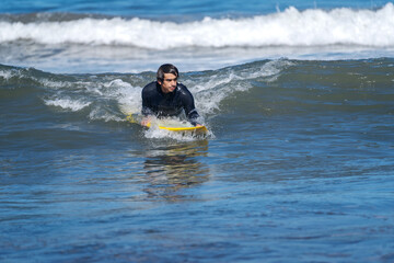 surfing the wave on the beach of La Serena Chile