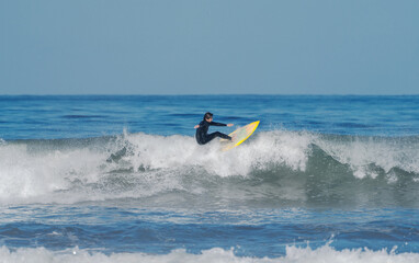 surfing the wave on the beach of La Serena Chile