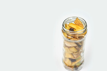 A jar filled with banana peel cuts and water. Banana peel for plant fertilization. Eco friendly natural way of fruit waste compost. Banana peel compost