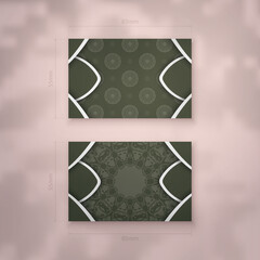 Business card template in dark green color with mandala white ornament for your business.