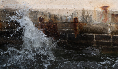 Splashing water on rusted dock 