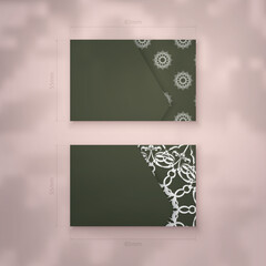 Business card template in dark green with Indian white ornaments for your personality.