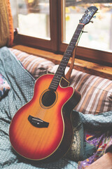 Acoustic guitar resting on a sofa_2