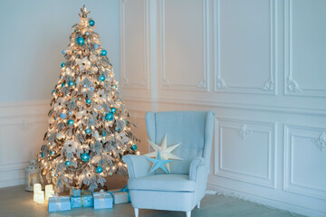 Full-length Christmas decoration of a New Year tree next to a sofa for relaxing