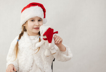 New Year's holiday. Portrait of a little girl with a Christmas style and gifts.
