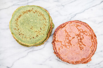 Close-up of pink beetroot pancakes and green spinach pancakes