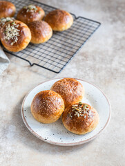 Sweet pumpkin buns with cinnamon and anise, light concrete background.