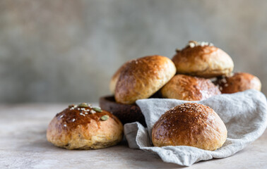 Sweet pumpkin buns with cinnamon and anise, light concrete background.
