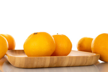 Several ripe organic tangerines in a plate made of wood, close-up, isolated on white.