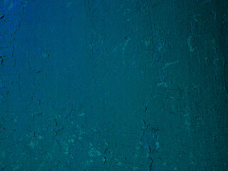 A surface of old blue damaged paint on a wall.