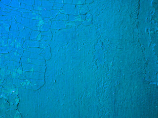 Abstract background of damaged cracked blue plaster.