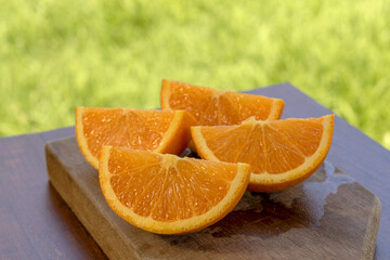 Sweet Chilean orange, cut on a wooden board