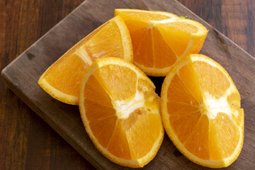 Sweet Chilean orange, cut on a wooden board