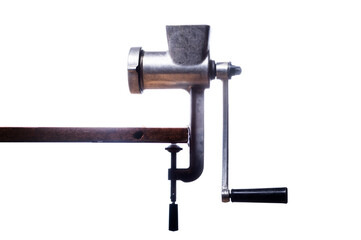 Old iron grinder on a white background. Meat grinder of the Soviet era. Side view of a meat grinder.