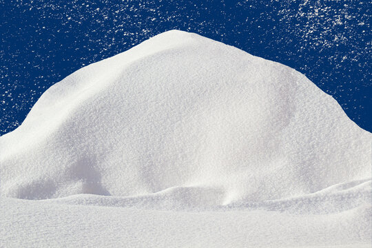Pile of snow with copy space on blue background with falling snow texture