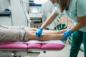 Young woman receiving laser epilation or permanent body hair removal treatment. Modern technology and beauty concept.