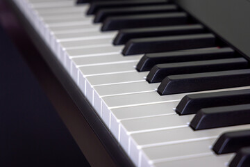 Closeup of classical electronic piano keyboard with black ebony and white ivory key. Musical instrument.