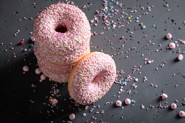 Sweet and homemade pink donuts as takeaway dessert