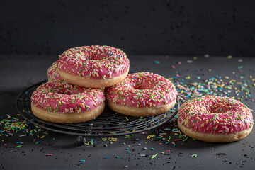 Colorful and tasty pink donuts freshly baked
