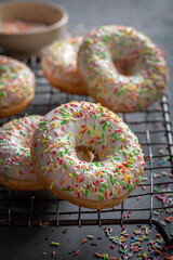 Homemade and delicious white donuts with glaze and sprinkles