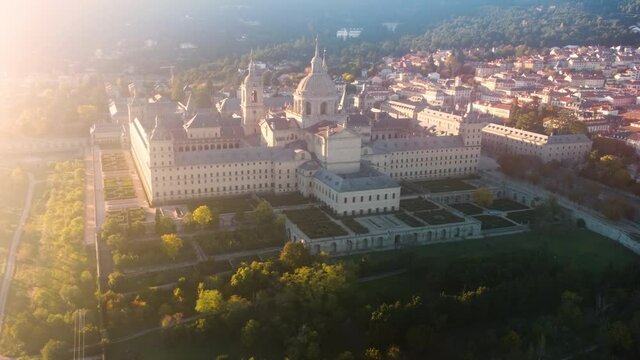 El Escorial. Royal architectural complex of the XVI century. Drone flight over Escorial at the sunset light, Spain.
