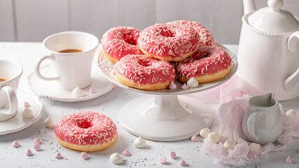 Yummy and sweet pink donuts and coffee as best dessert.