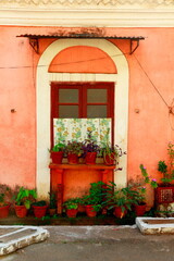 Obraz na płótnie Canvas Window with flower pots in old colonial area of Panaji, Goa, India.