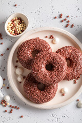 Popular and fresh chocolate donuts and coffee as perfect snack.