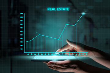 Business investment concept. Person holding smartphone with Abstract graph real estate growth