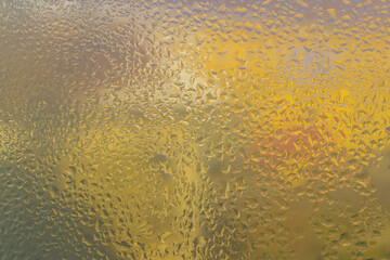 raindrops on the glass. Yellow natural background.
