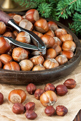 Heap of hazelnut on  wooden table with nutcracker