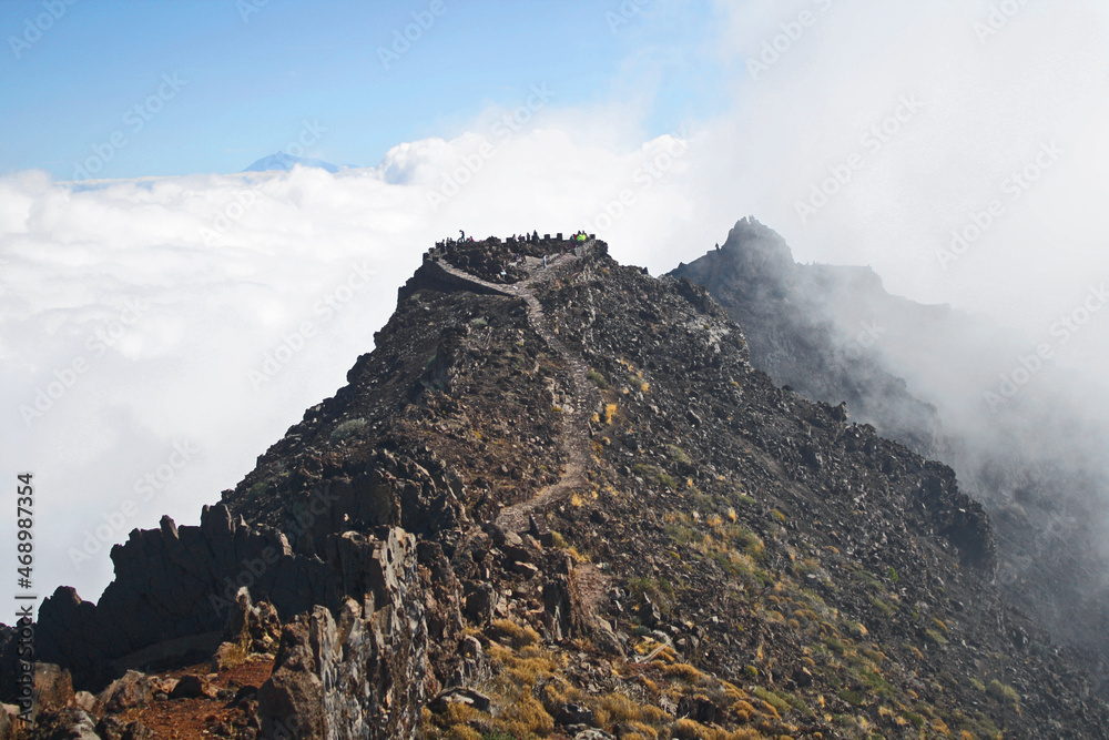 Wall mural mountain between clouds, volcano crater