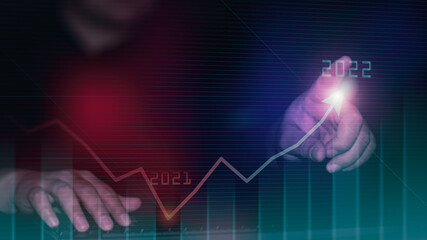Plan business growth in year 2022 concept. Businessman plan and increase of positive indicators in his business, Growing up business concepts. Businessman pointing arrow graph corporate future growth 