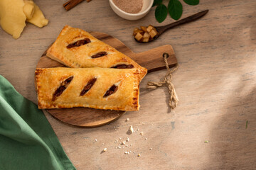 Baked apple hand pie in wooden background