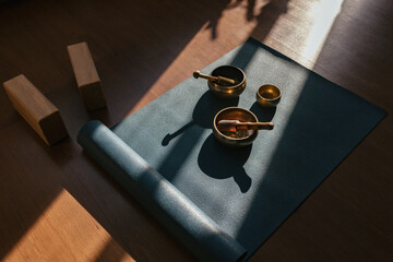Authentic tibetan singing bowls for meditation and relaxation on yoga mat. Sound massage and healng.
